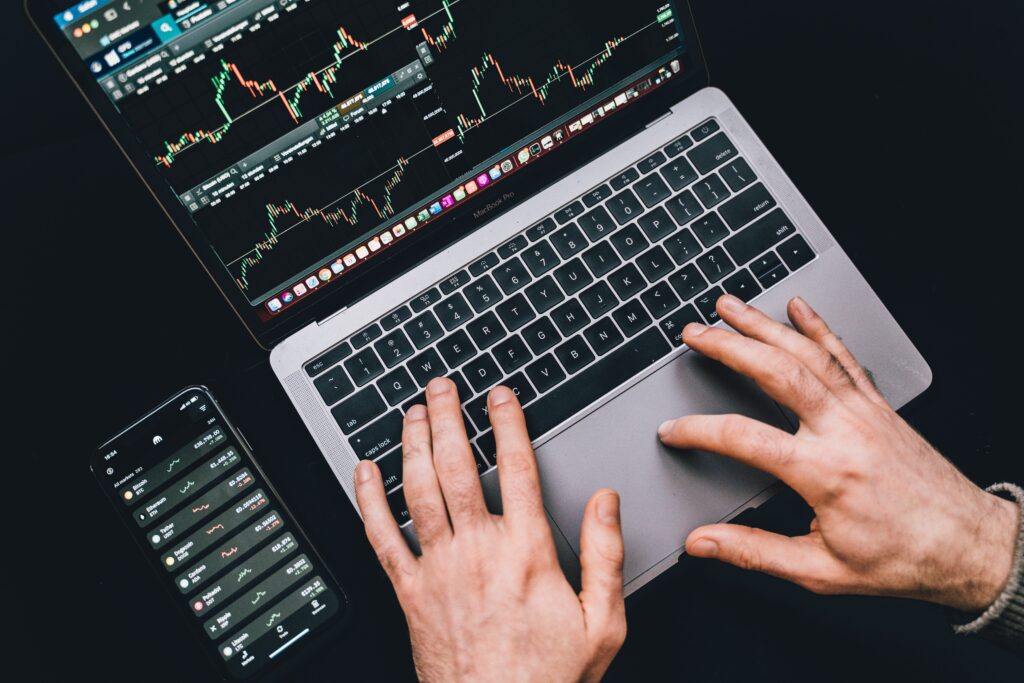 cryptocurrency and how it works : A Laptop and a smartphone with a cryptocurrency graph